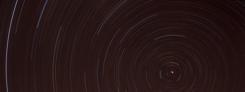 A night sky showing the brightly lit movement of stars.