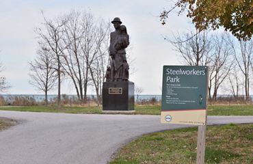 A statue sits next to a pathway at Chicago's Steelworkers Park.