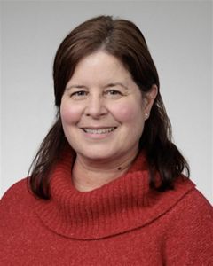 A woman wearing a red sweater. 