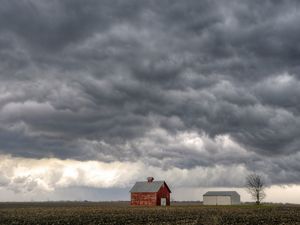 Dramatic gray clouds form on the horizon over an Illinois farm.