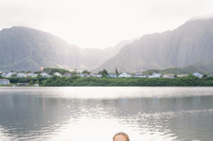 Hi‘ilei Kawelo stands waist deep in the He‘eia fishpond.
