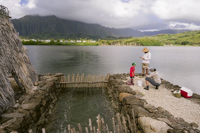 People fish in Kaneohe, Hawaii, on a community fishing day.