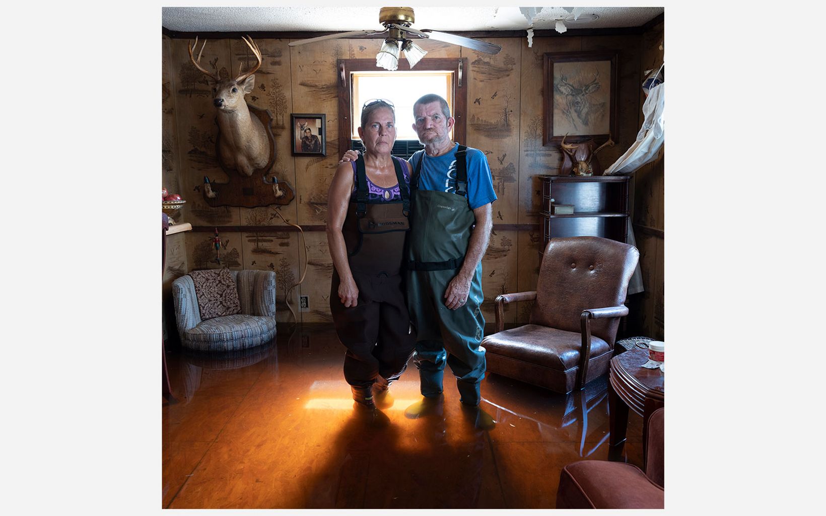 Kimberly and Rudy Fralix stand in their flooded home