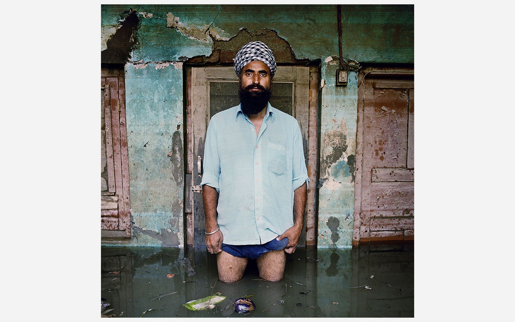 J.B. Singh stands in water deeper than his knees in Kashmir, India 