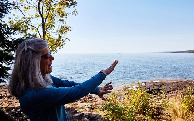 Overlooking Lake Superior, Susan Fuad explains the impact of reforestation on the health of the lake.