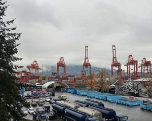 A shipping yard with large containers and wood packaging materials.