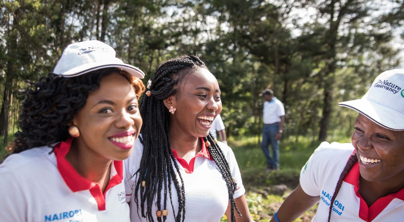 Three young women laughing.