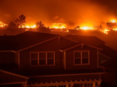 House with a fire raging in the background.