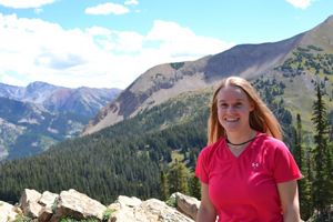 Tamara Gagnolet stands in front of a mountain range.