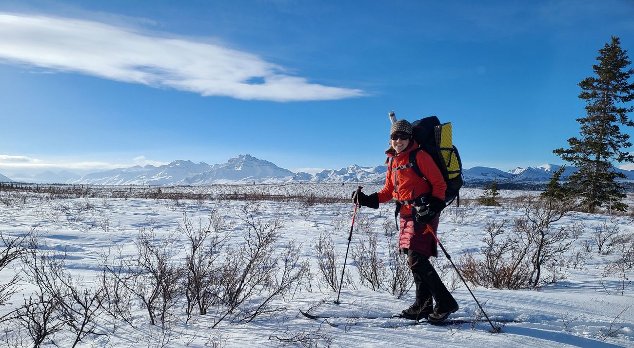 Taylor Ganz hikes in snow with a backpack.