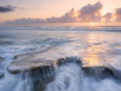 Rocky Florida ocean shoreline at sunrise.