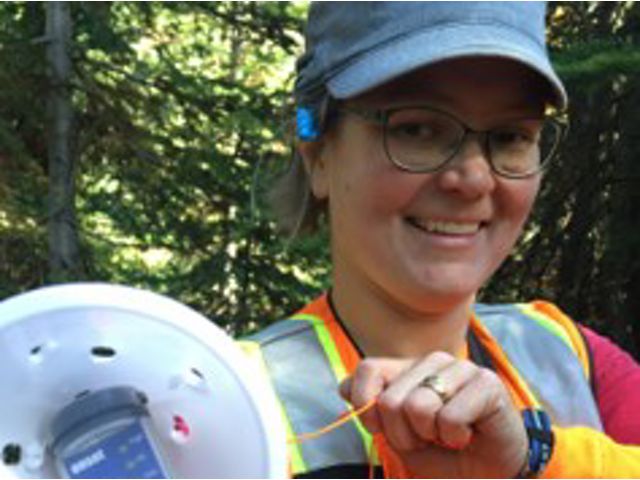 Susan Dickerson-Lange shows off a temperature sensor that will track snow melt at a research site. 
