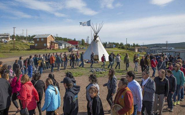 Members of the Łutsël K’é Dene First Nation dance in a large circle.