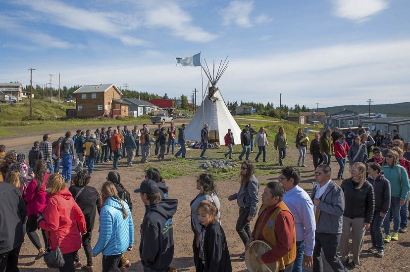 Members of the Łutsël K’é Dene First Nation dance in a large circle.