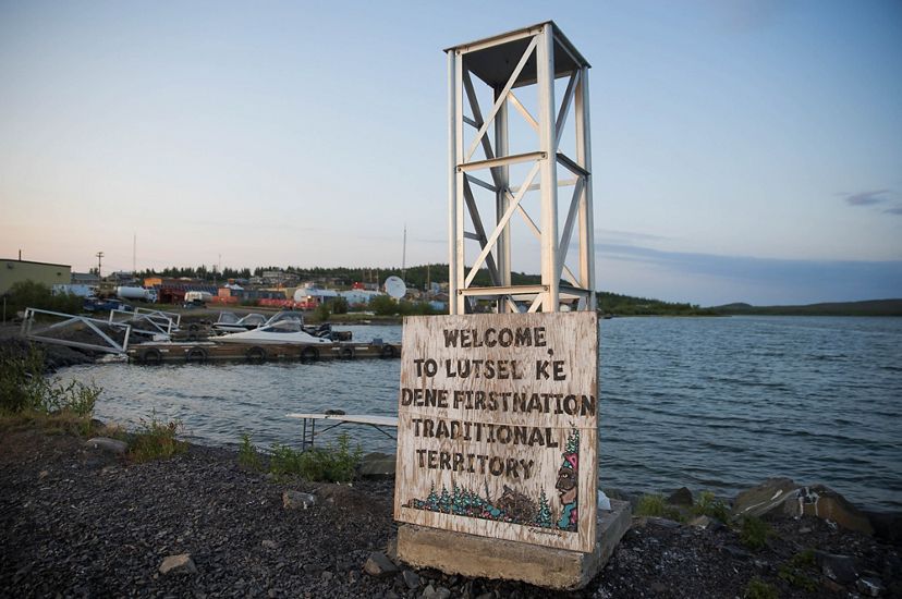 A sign on a pier welcomes visitors to Łutsël K’é. 