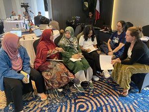 A group of people sit together at a workshop.