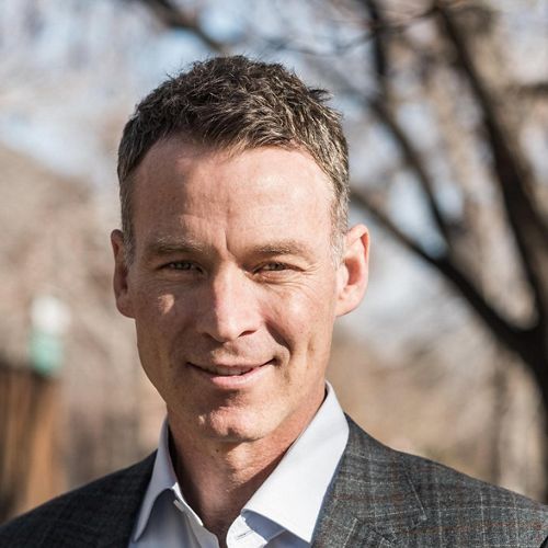 man in suit jacket smiling