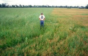 Chad Bladow stand in an open field on his first day with TNC.