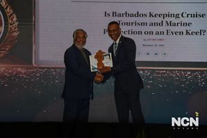 A man accepts an award from another man.