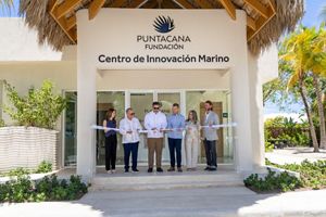 A group of people stand for a ribbon cutting ceremony at the Center for Marine Innovation in Punta Cana, Dominican Republic.