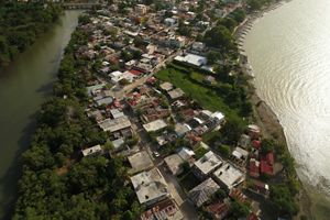 An aerial view of town on a peninsula surrounded by the Rio Yeguada and the Caribbean Sea.