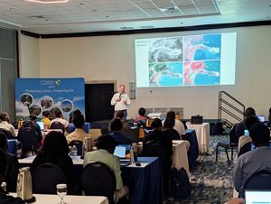 Dr. Steve Schill gives a presentation at a workshop in front of stakeholders. 