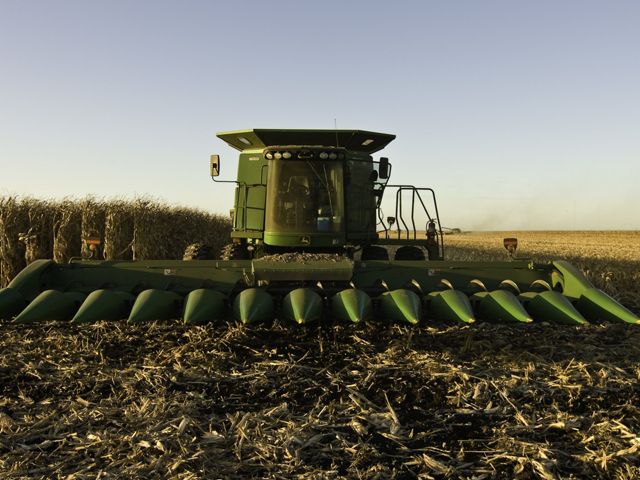 A close up of a green tractor in a field.