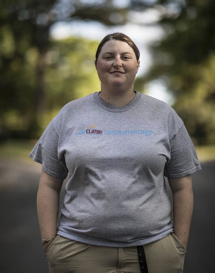 Lauren Kissel stands in a tree-lined road.