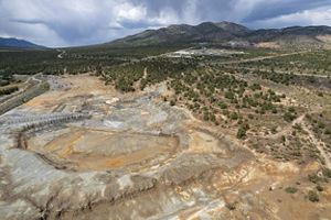 Disturbed mine lands in Nevada surrounded by desert and mountain landscape. 