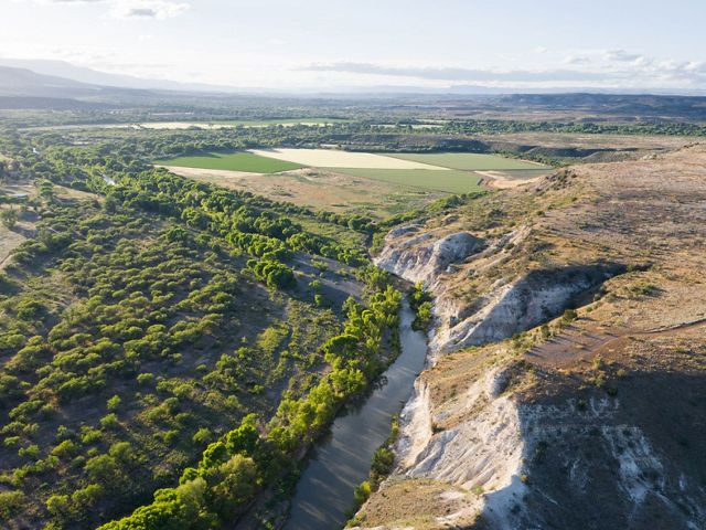 An aerial photo of a river running through cliffs in the Verde Valley in Arizona.