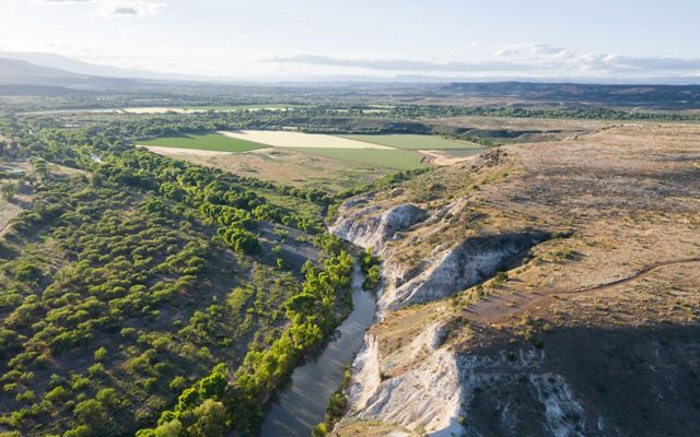 An aerial photo of a river running through cliffs in the Verde Valley in Arizona.