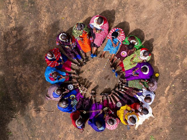 Maasai women sit together at the Randilen Enaboishu Women Trading Center crafting intricate pieces of beadwork.