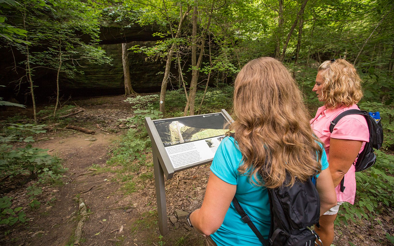 
                
                  Learning About the Preserve Hikers read interpretive signage at Mantle Rock Nature Preserve
                  © Mike Wilkinson
                
              