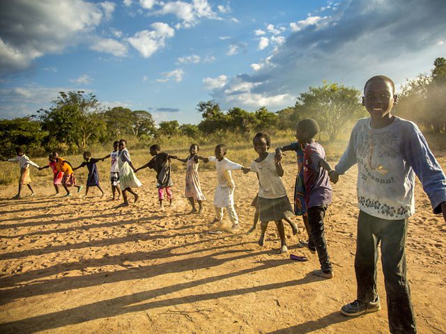 children holding hands in a circle