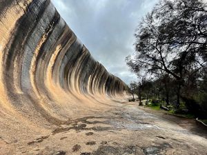 A giant rock formation looks like a breaking ocean wave.