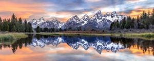 snow-sprinkled mountains reflected in the lake beneath them.