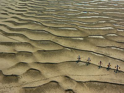 Carrying water at the Irrawaddy riverbank near Bagan city, Myanmar.