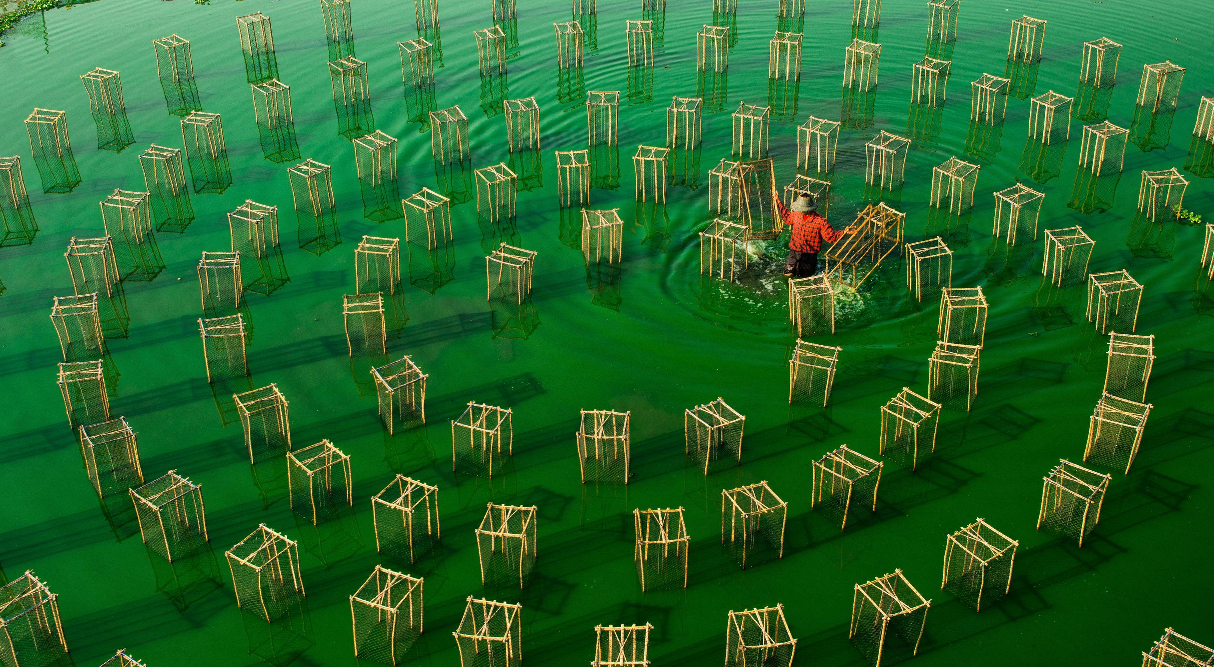 A fisherman tending to his fishing nets