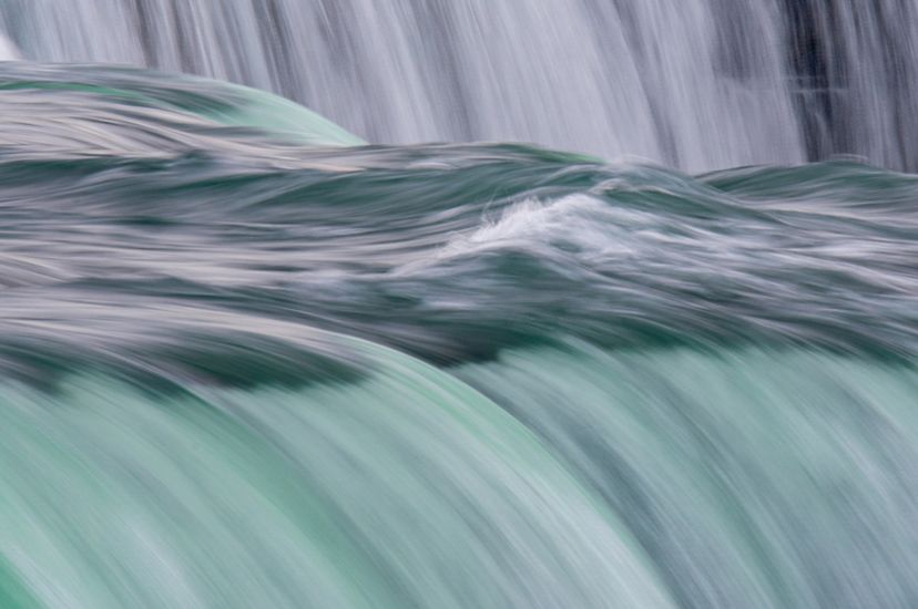 Close-up of water flowing over the crest of Niagara Falls in New York.