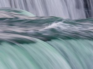 A zoomed-in photo of water rushing over Niagara Falls.