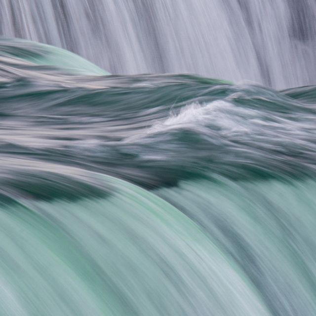 A zoomed-in photo of water rushing over Niagara Falls.
