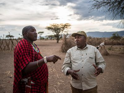 Photo of two men talking about cattle grazing in northern Tanzania.