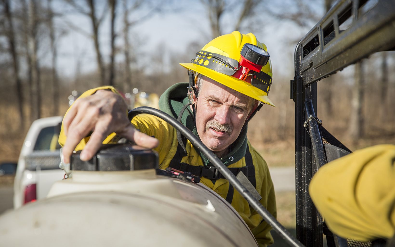 Prescribed Fire Checking a water tank before a prescribed fire in Kentucky. © Mike Wilkinson