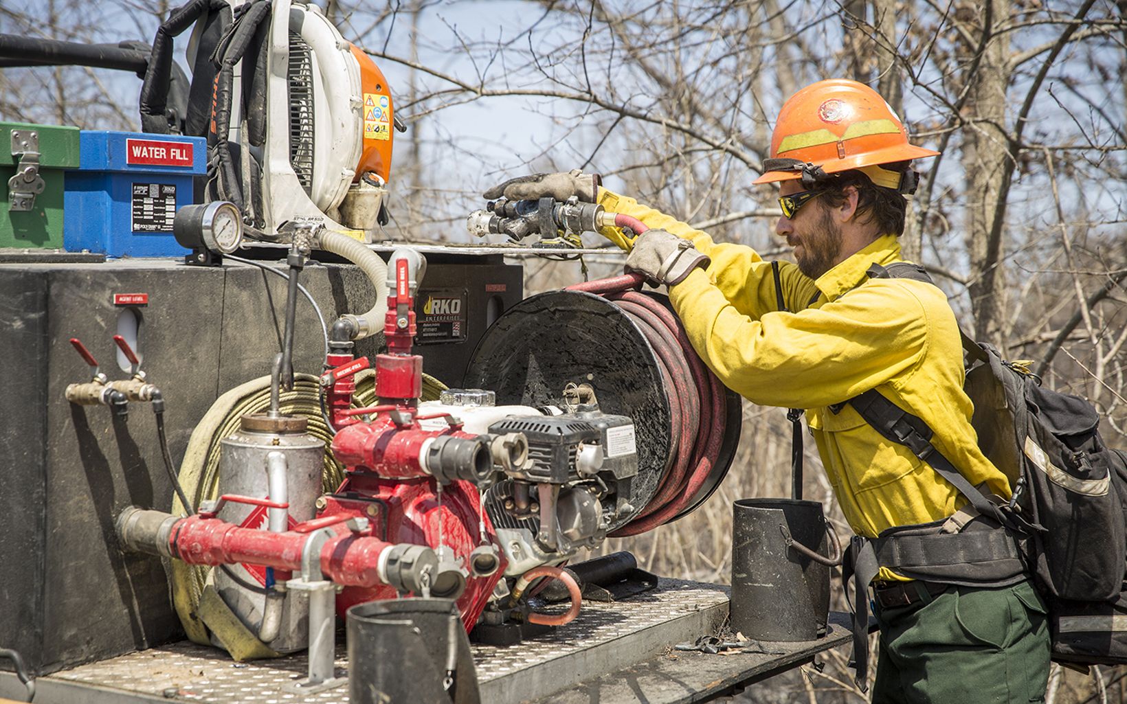 Prescribed Fire Pickett checks a water hose before a prescribed burn. © Mike Wilkinson
