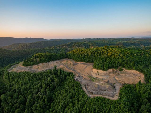 Coal mine on mountain at sunset.