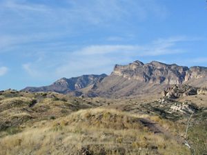 Rocky cliffs against a bright blue sky.
