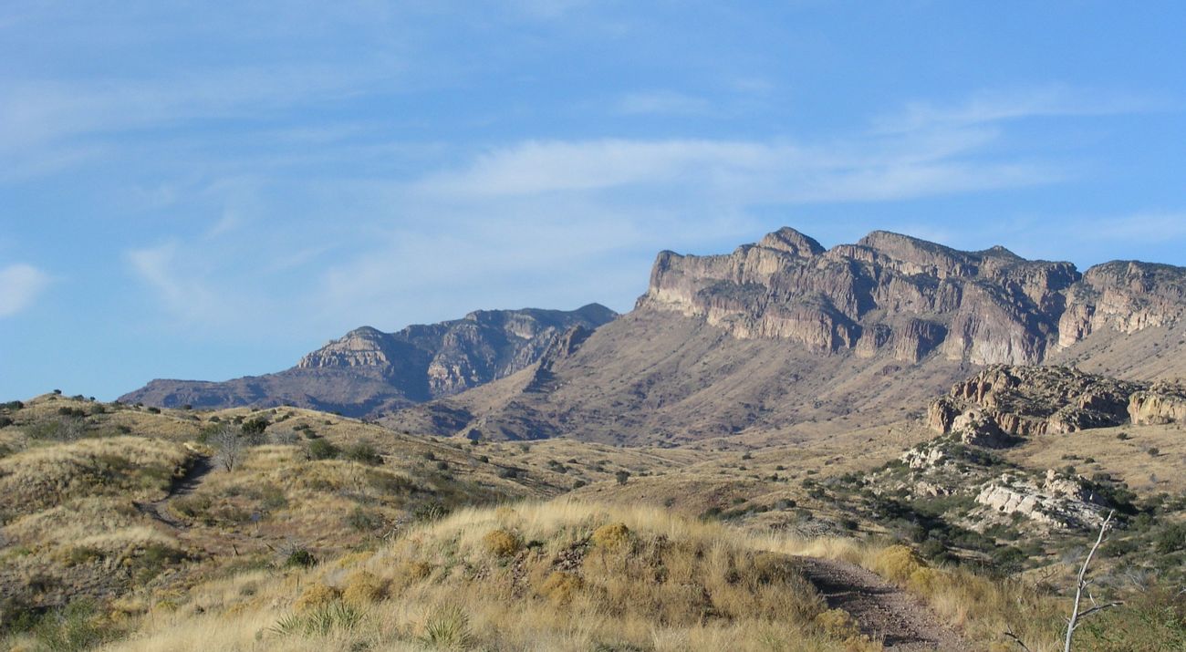 Rocky cliffs against a bright blue sky.