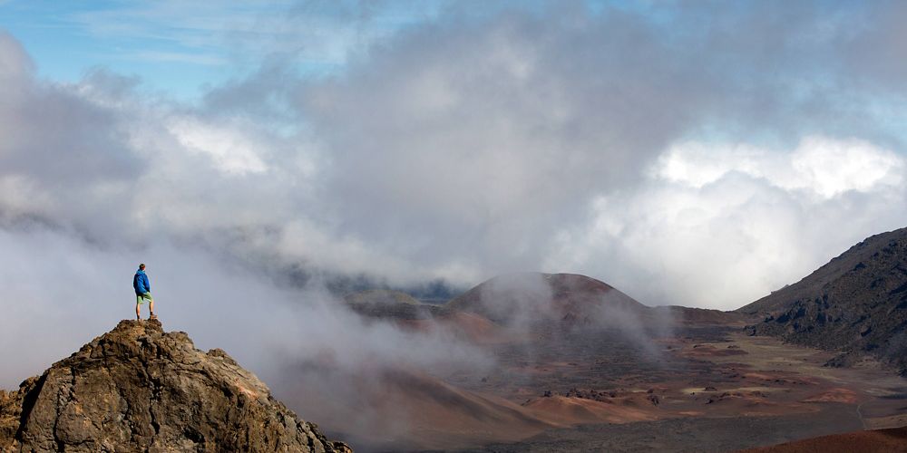 TNC staff Axel Brunst stands on a rock inside the creater of Haleakala National Park.