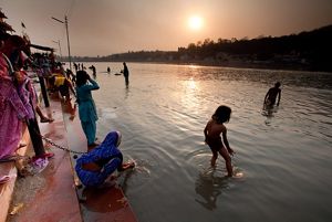 A group of people wading in a river.