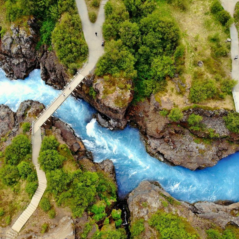 Aerial view of a bridge over glacial water in Barnafoss, Iceland.